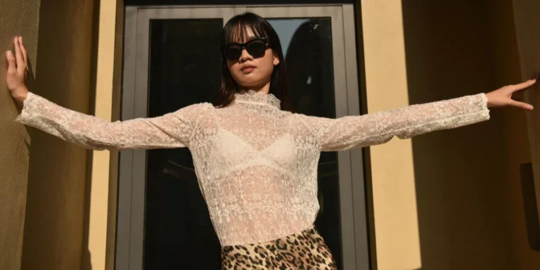 Woman Posing in White Lace Blouse and Leopard Print Skirt