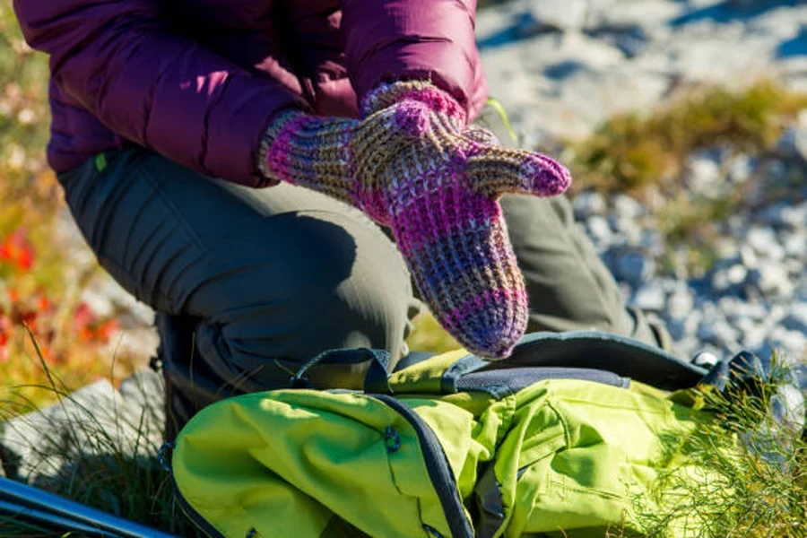 Woman Putting Her Gloves on While Hiking in the Julian Alps