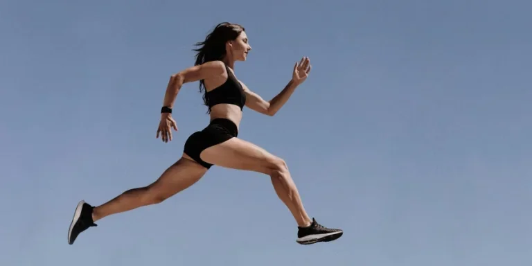 Woman in Black Sports Bra and White Shorts Jumping