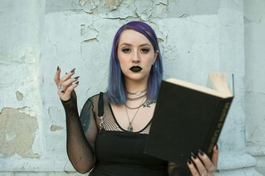 Woman in Black Top Holding a Book