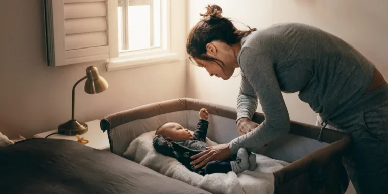 Woman putting her baby to sleep in a smart bassinet