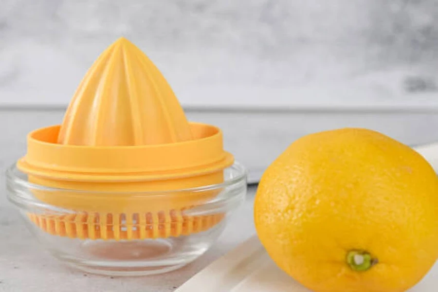 Yellow plastic citrus reamer with round glass base