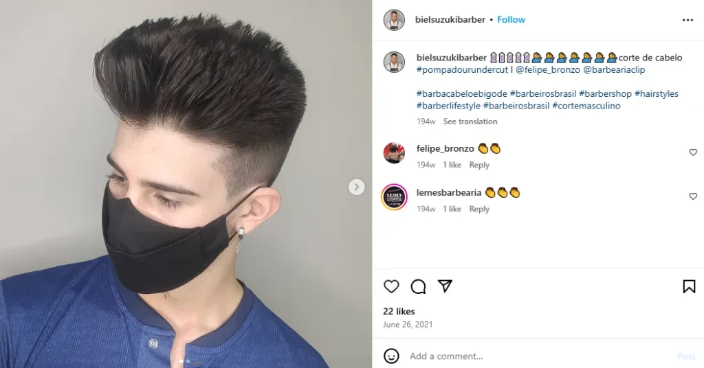 A barber showing off his clean pompadour undercut
