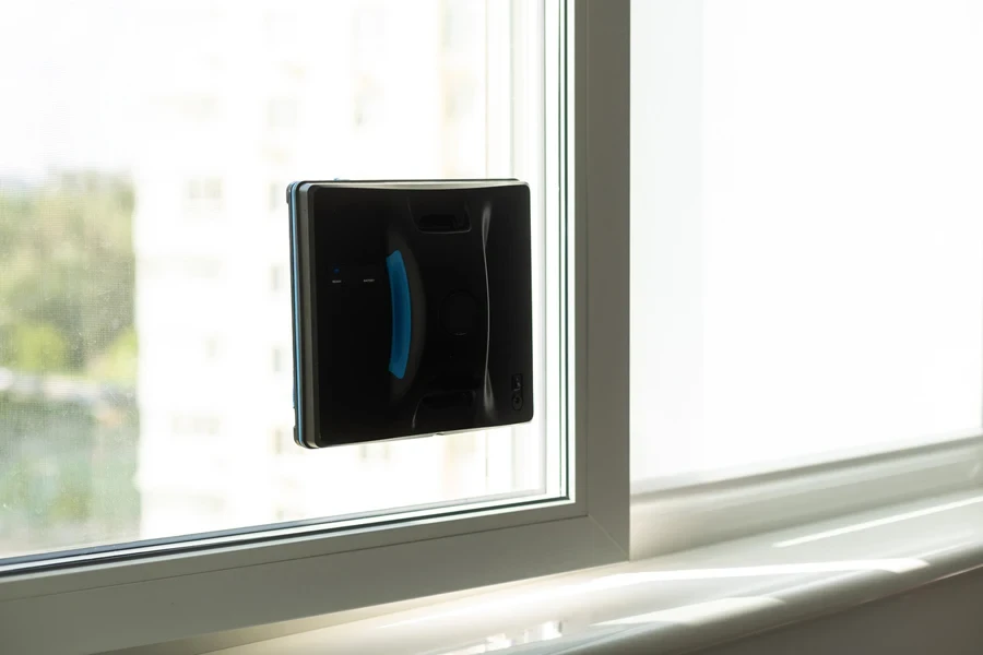 A black robotic window cleaner on a window