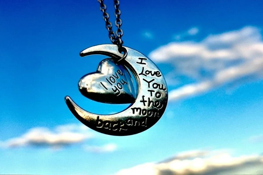 A crescent with a heart hanging with engraved message