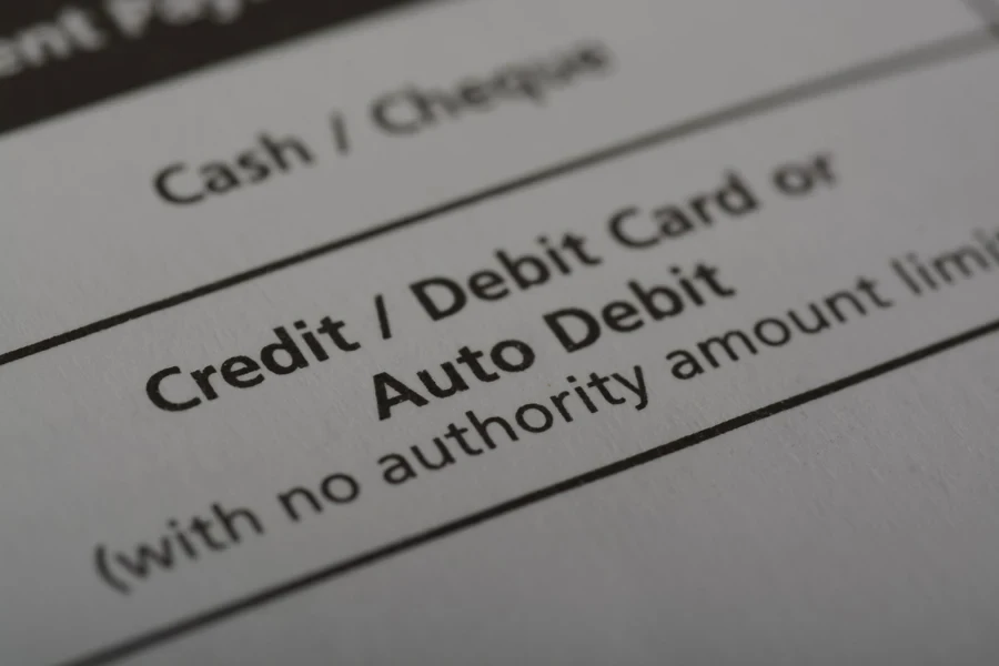 A document with credit, debit card, or auto debit