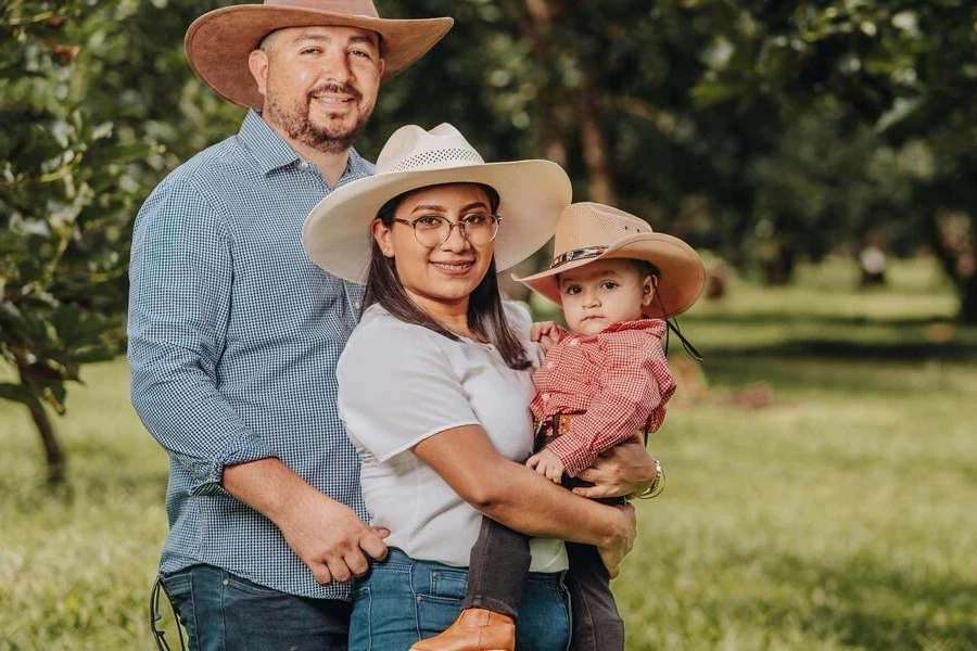 A family photographed wearing cowboy hats