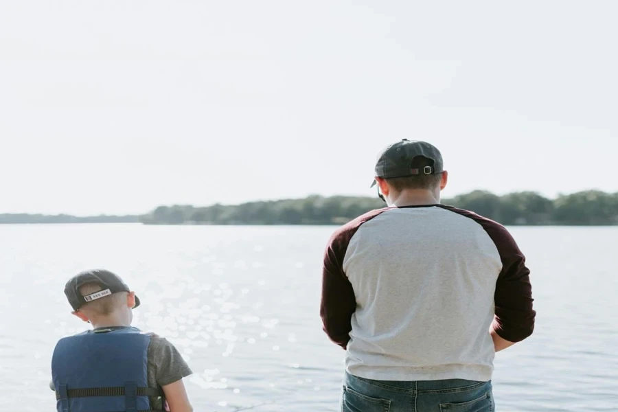 A father and son fishing on water