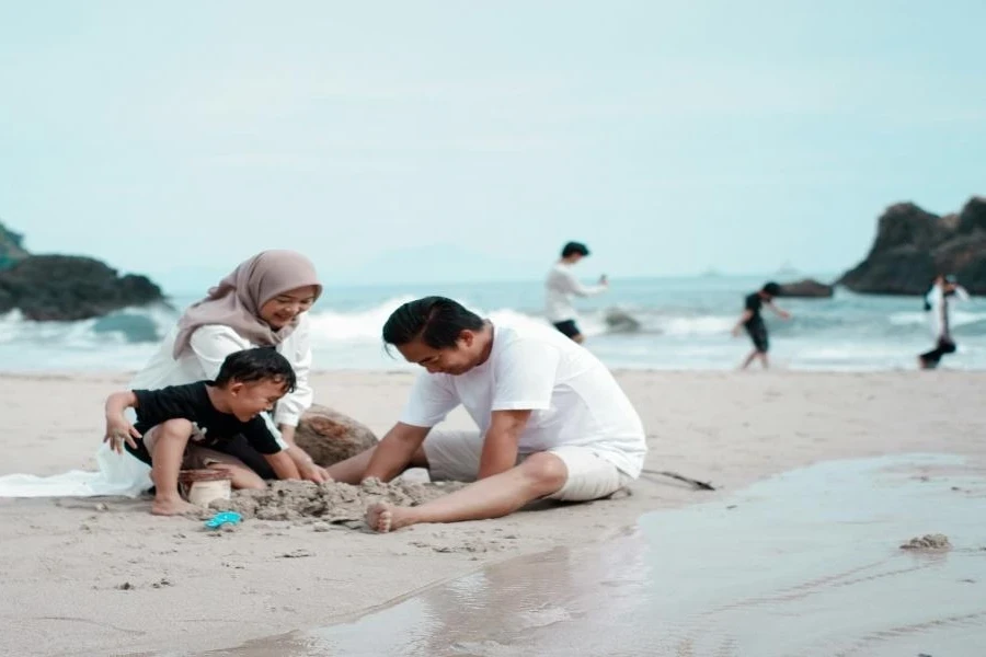 A father playing with his family on a beach