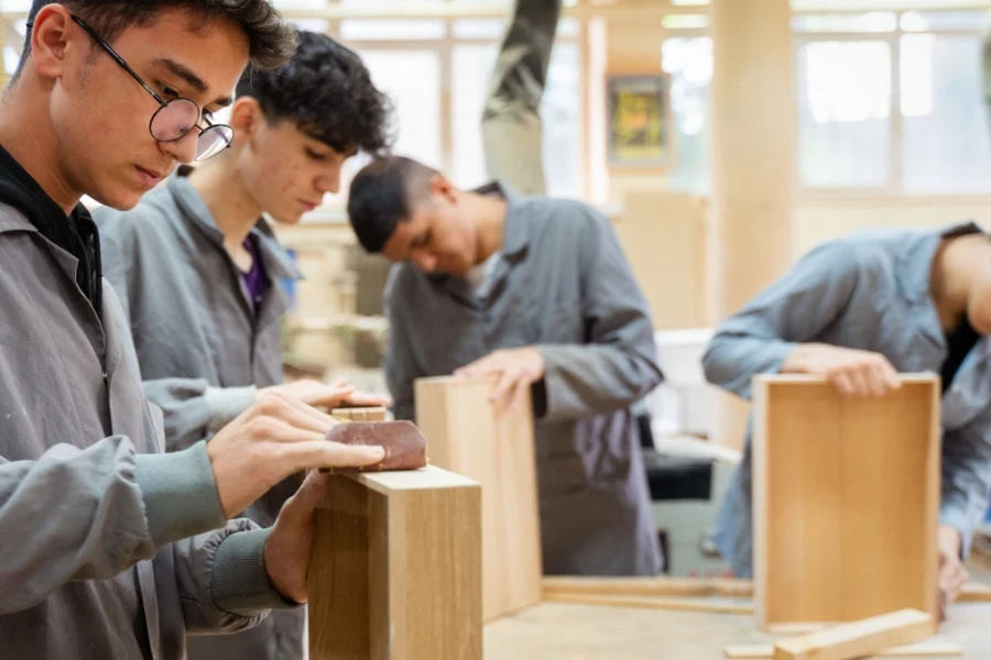 A few people working in a wood workshop