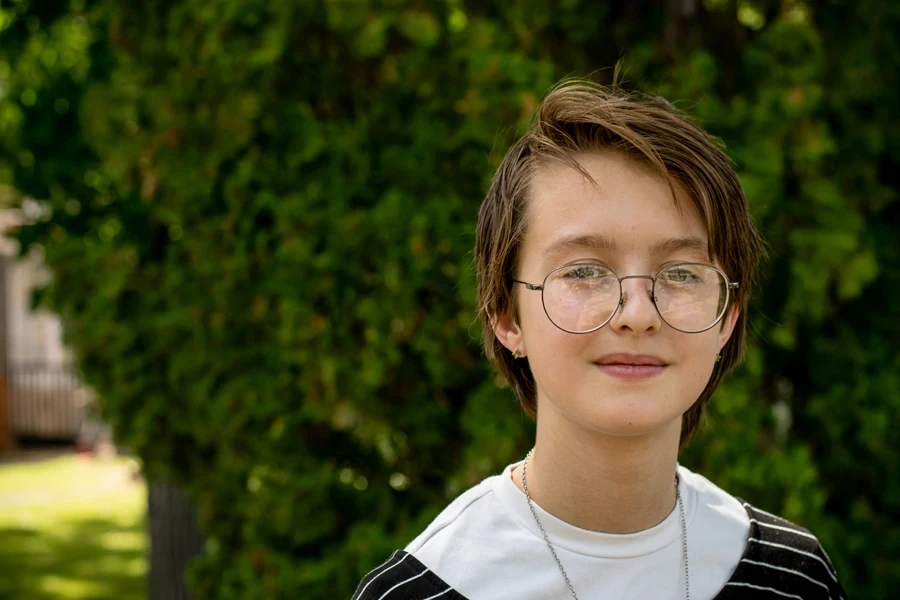 A girl with glasses rocking a pixie cut