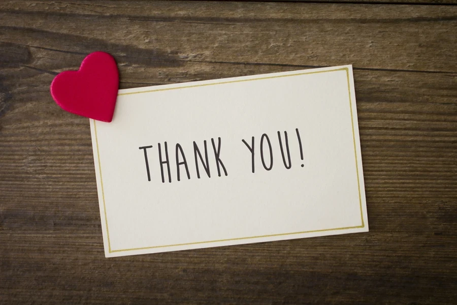 A hand-written thank you note with a heart
