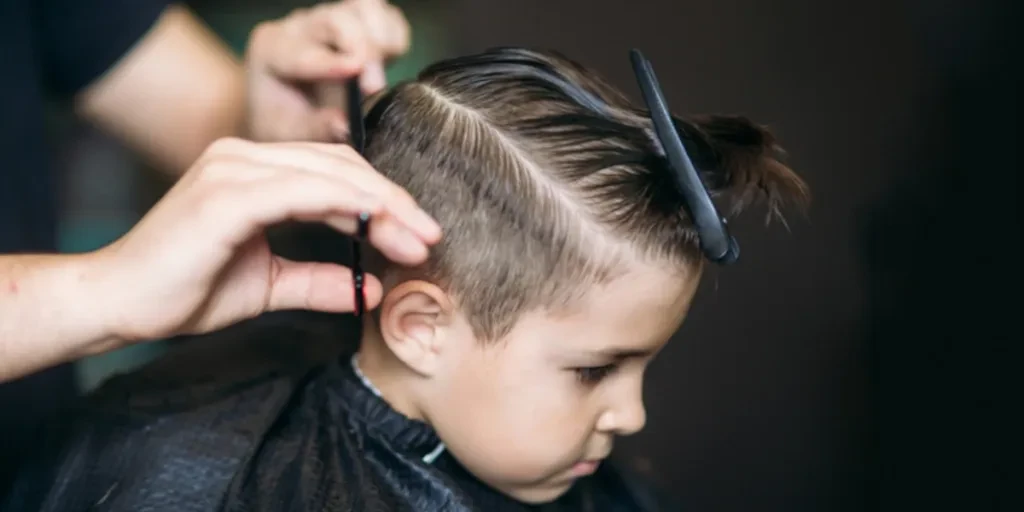 A kid getting a haircut at a barber’s shop