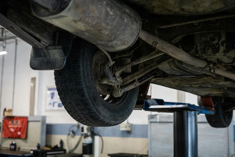 A lifted car showing the wheels and control arms