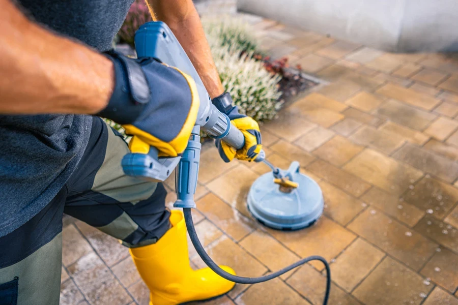 A man cleaning with a corded electric spin scrubber