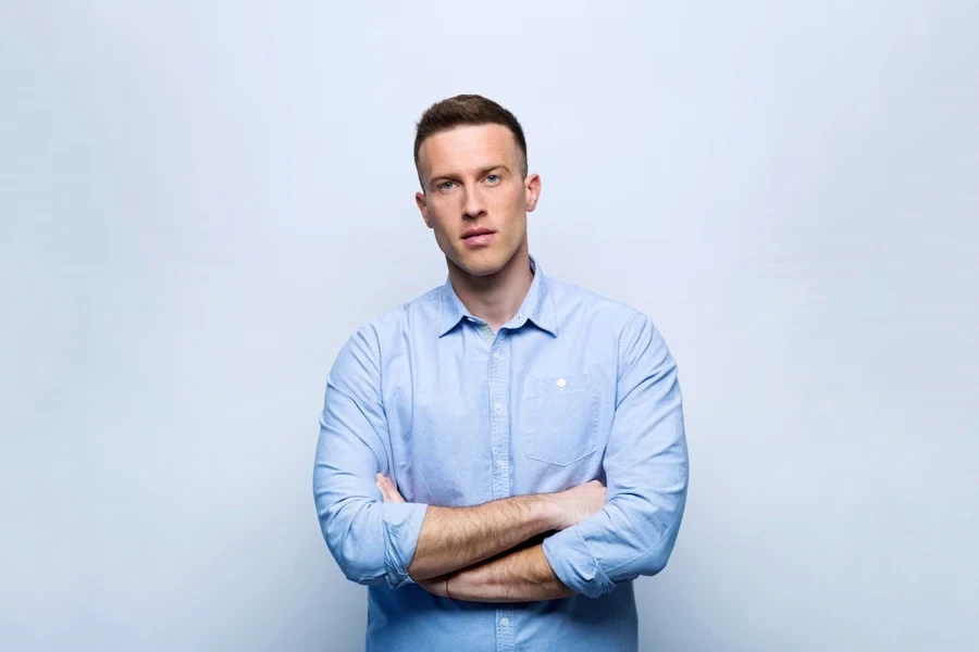 A man smiling and wearing a blue shirt