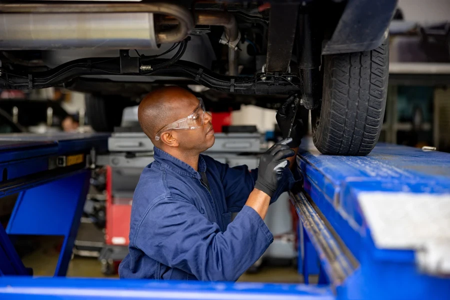 A mechanic fixing the suspension on a car