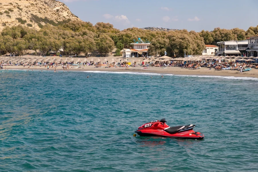 A picture of a red Kawasaki Ultra 250X on Matala Beach
