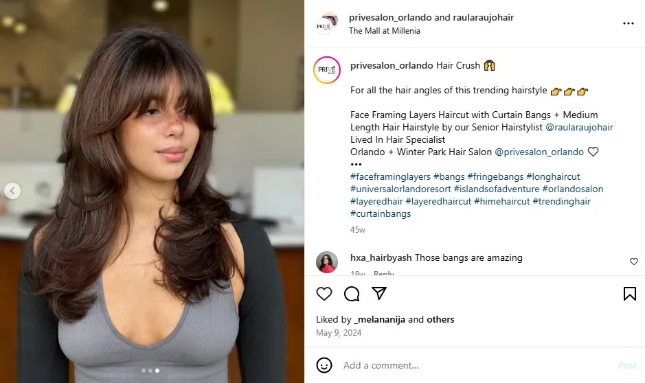 A screenshot of a lady showing off curtain bangs