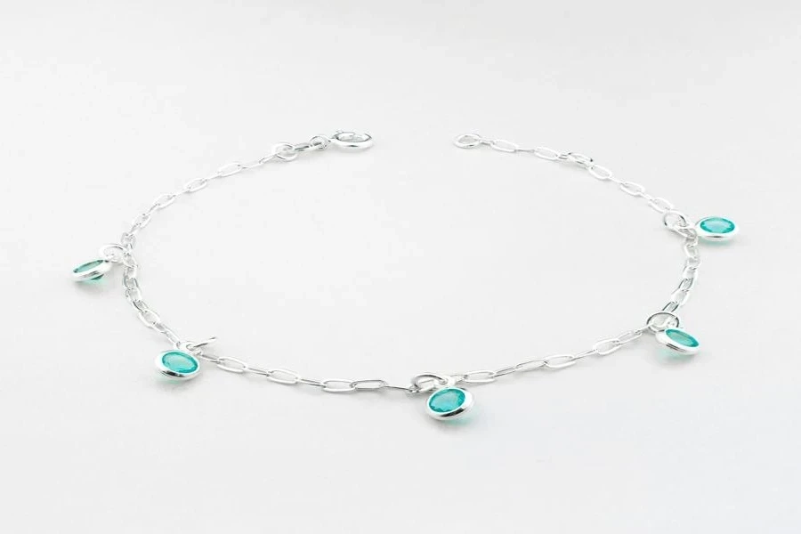 A silver bracelet with turquoise charms