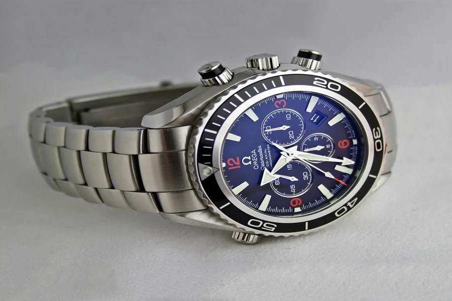 A silver watch with a blue face