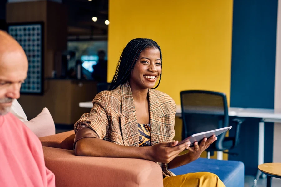 A smiling businesswoman in a plaid blazer