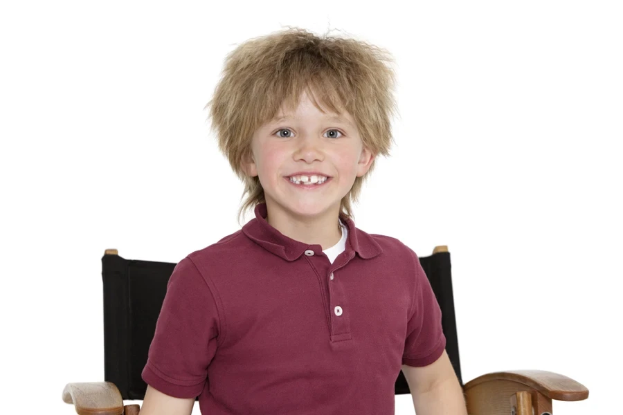 A smiling child with a shag cut