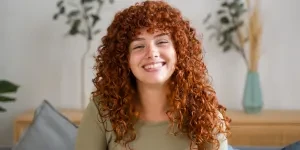 A smiling woman with red hair