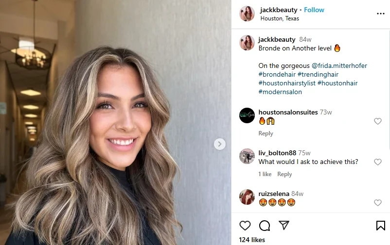 A smiling woman with sandy brown highlights