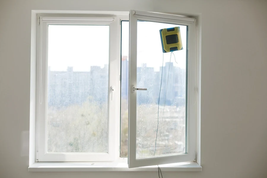 A square robotic cleaner cleaning a window