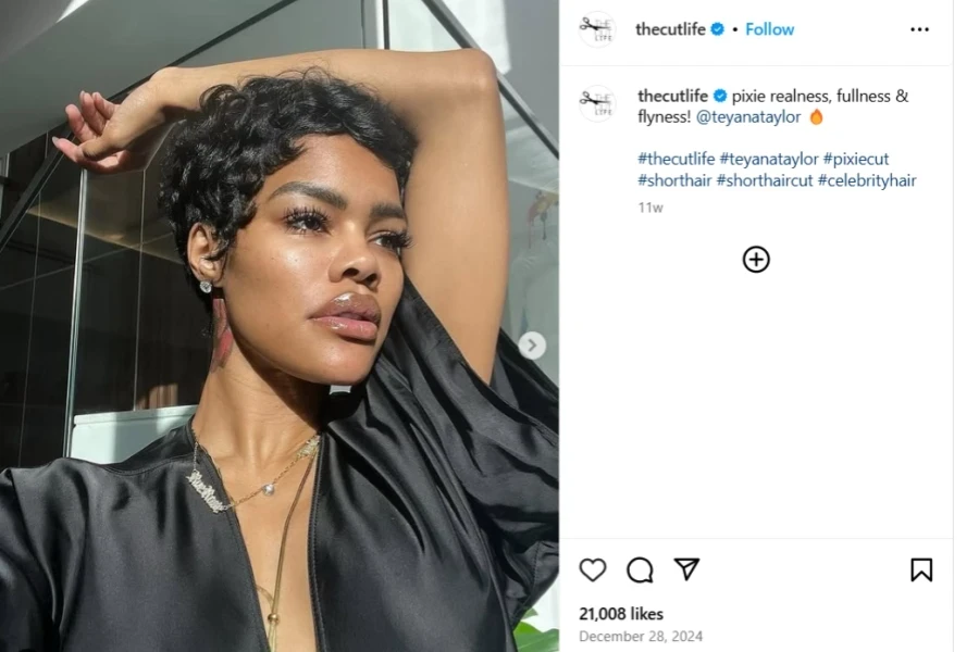 A woman posing with a stylish pixie cut
