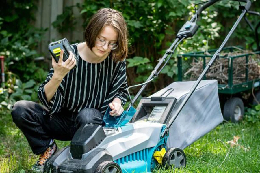 A woman setting up an AI lawnmower