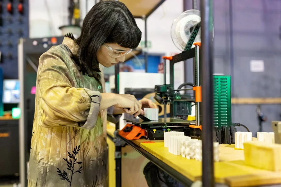 A woman using a 3D printer