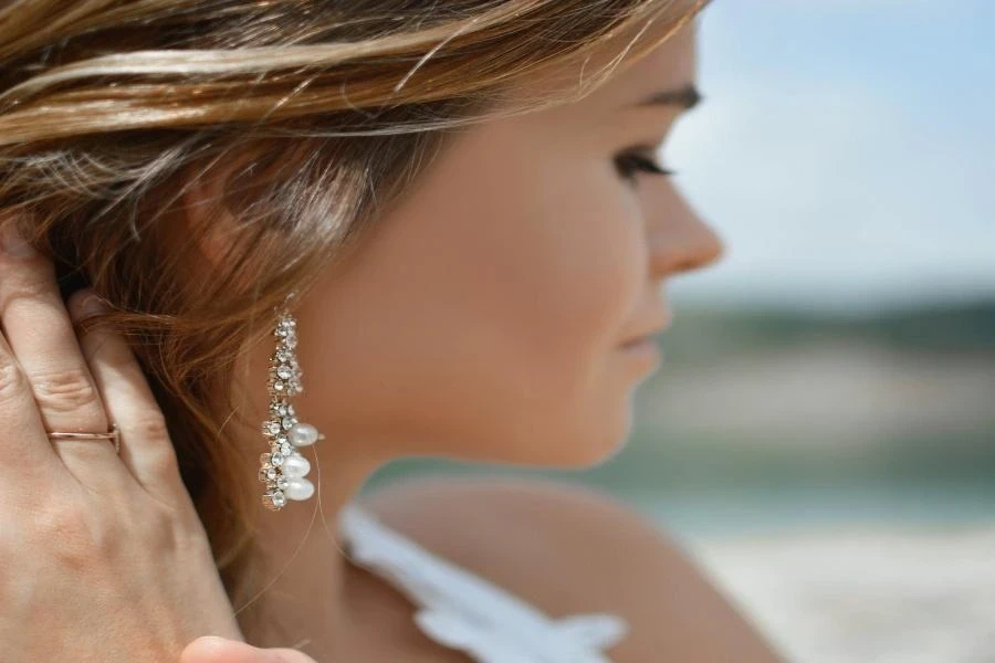 A woman wearing a dangly earring