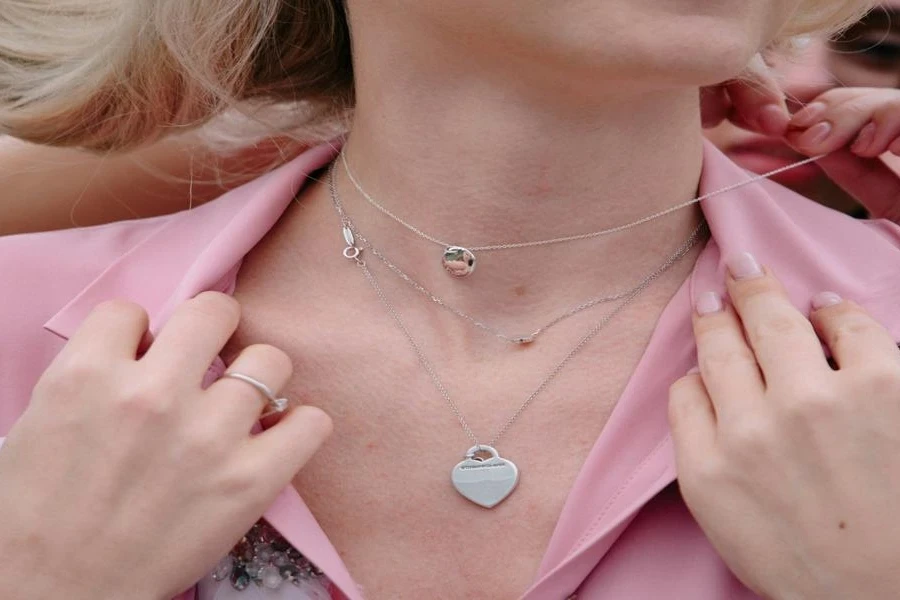A woman wearing a pendant necklace