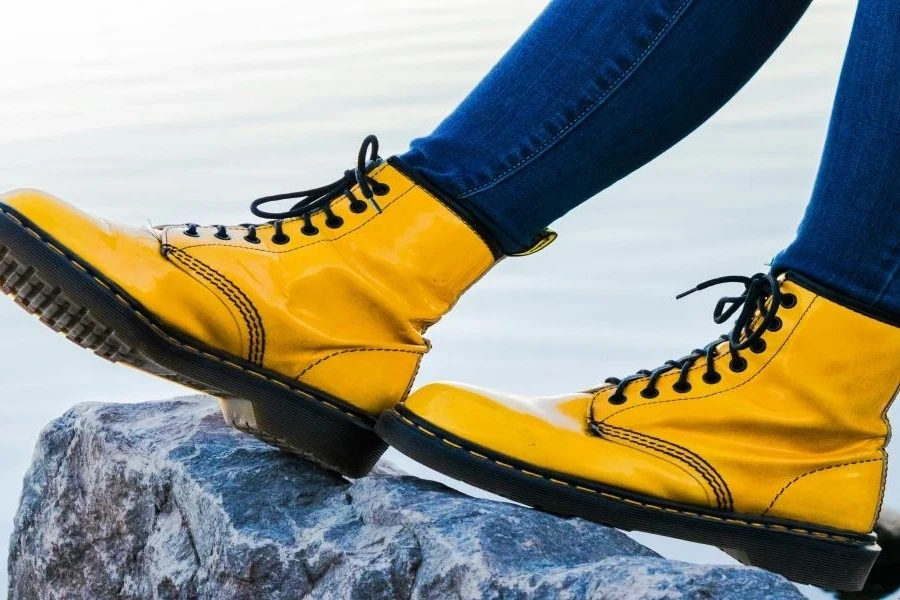 A woman wearing yellow combat boots