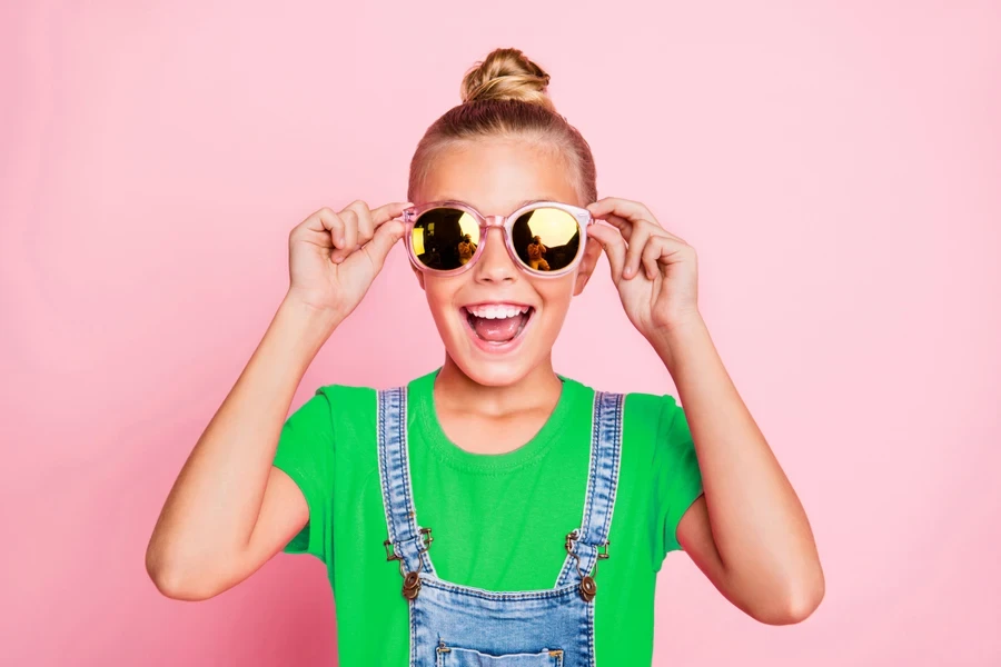 An excited girl with a top knot hairstyle