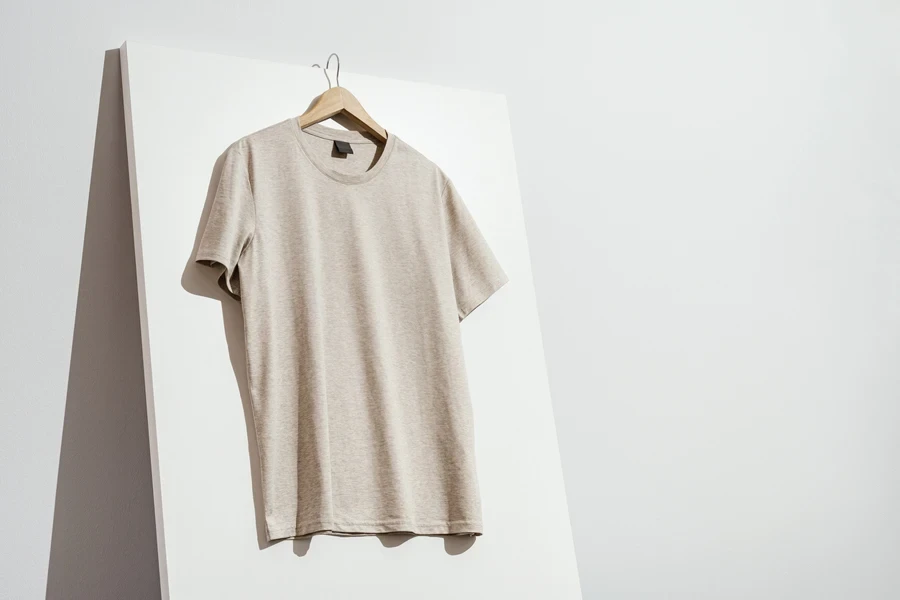 Beige t-shirt mockup on a wooden hanger