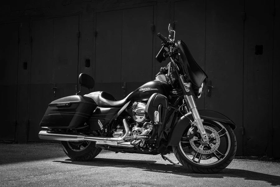 Black and white photo of a motorcycle parked in front of a building
