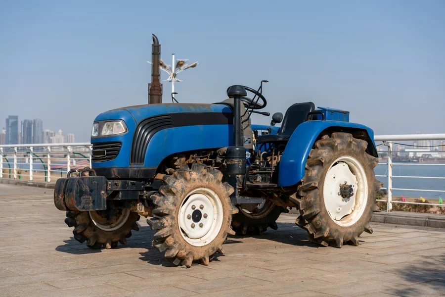Blue tractor on a clear sky background