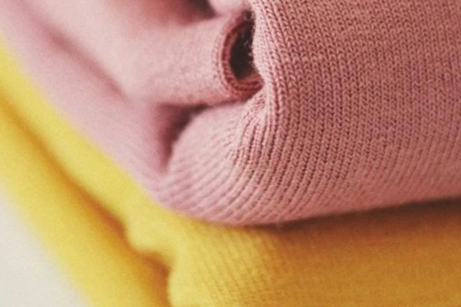 Bundles of pink and yellow wool fabric