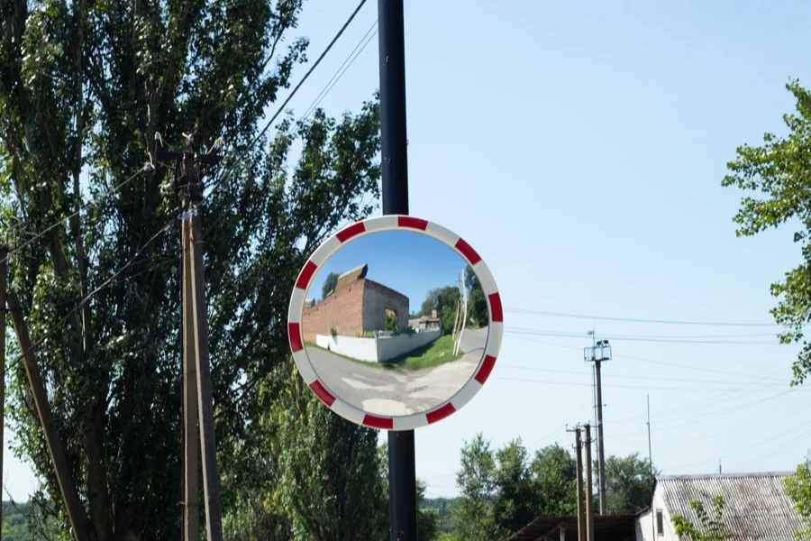 Convex security mirror on lamppost with caution tape around it