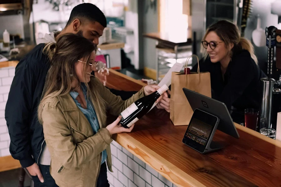 Couple buying a bottle of wine at a store