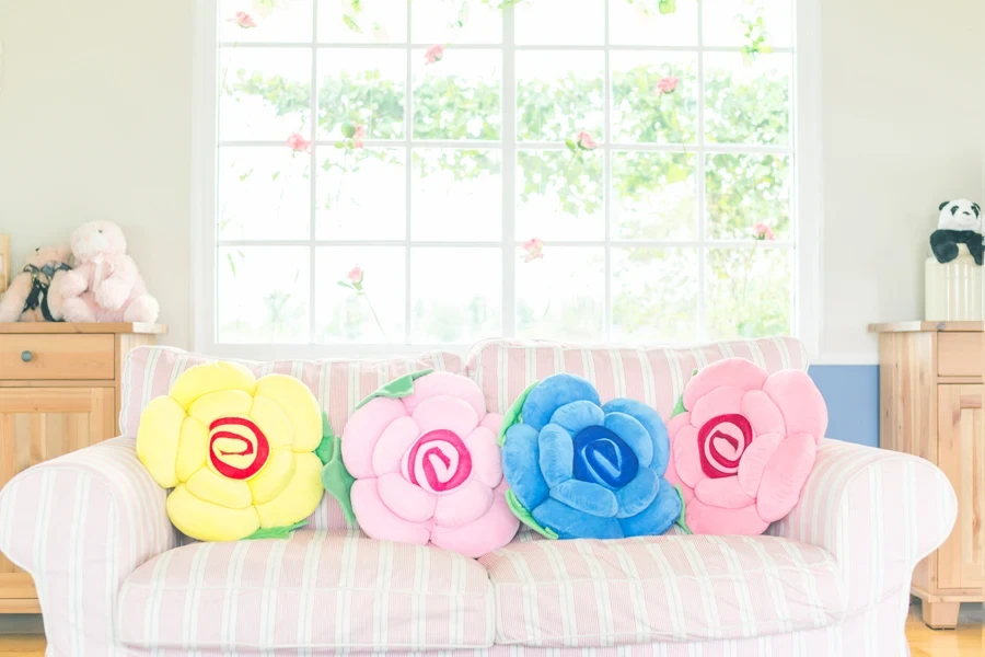 Customized throw pillows on a white and pink couch