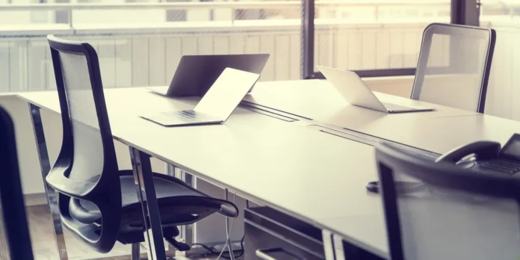 Empty office with laptops on desk