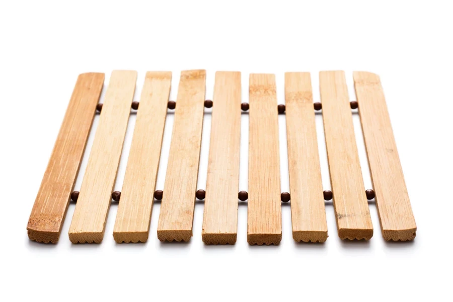 Expandable bamboo trivet on white background