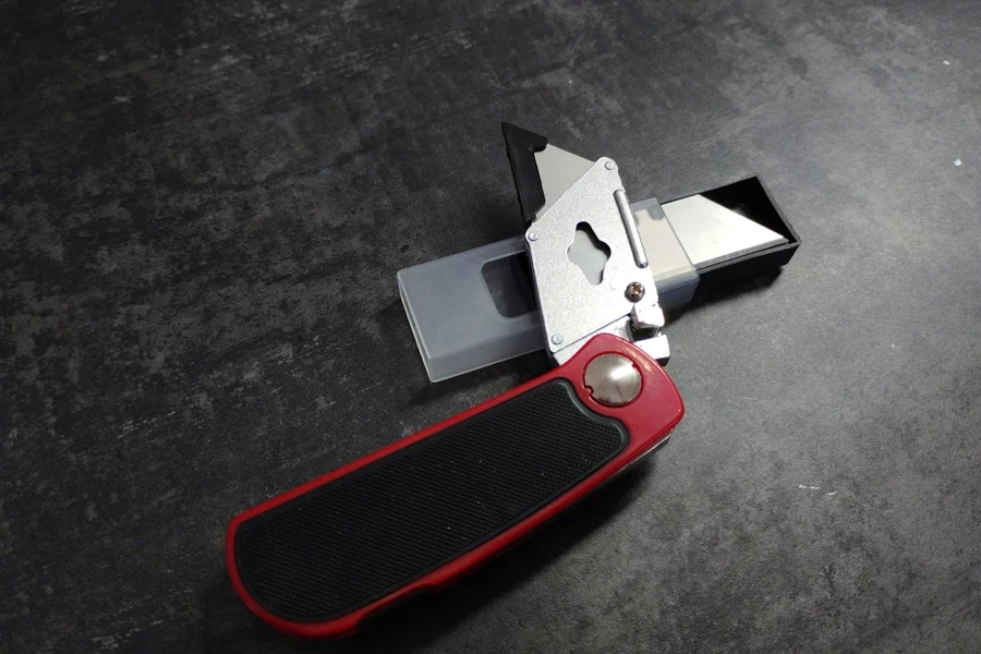 Folding utility knife with rubber ergonomic handle in red
