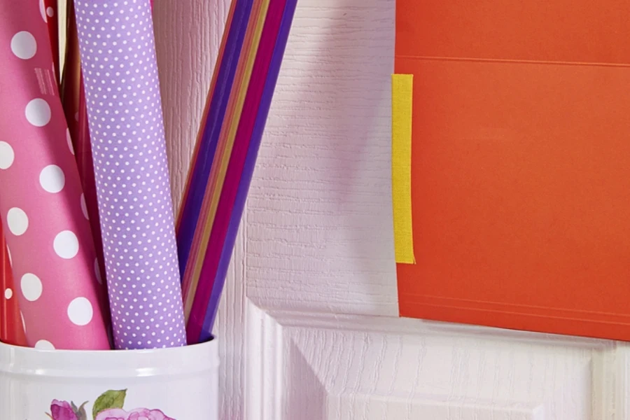 Gift paper rolls in metal container on door
