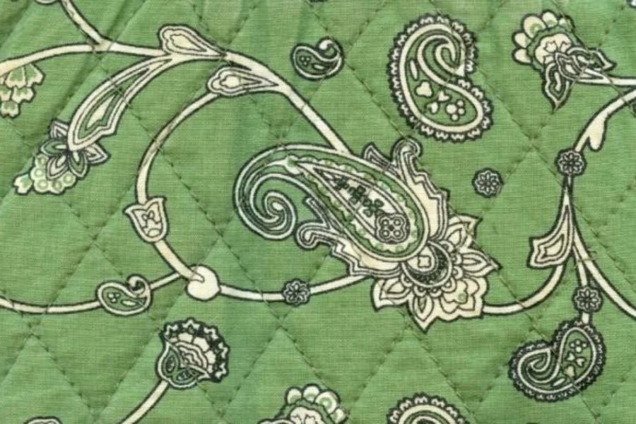 Green quilt pattern textile with antique print