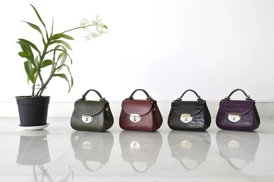 Leather handbags in different colors lined together
